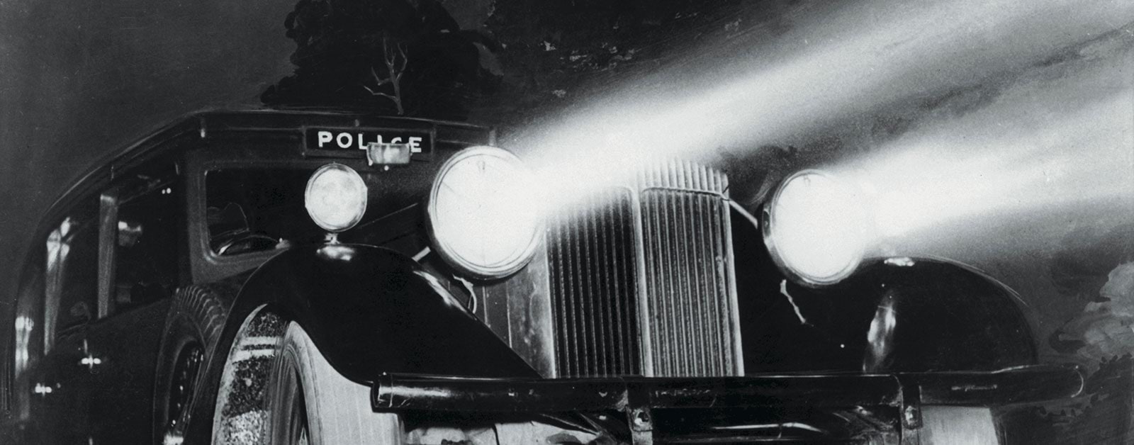 Photo of early police car at nighttime